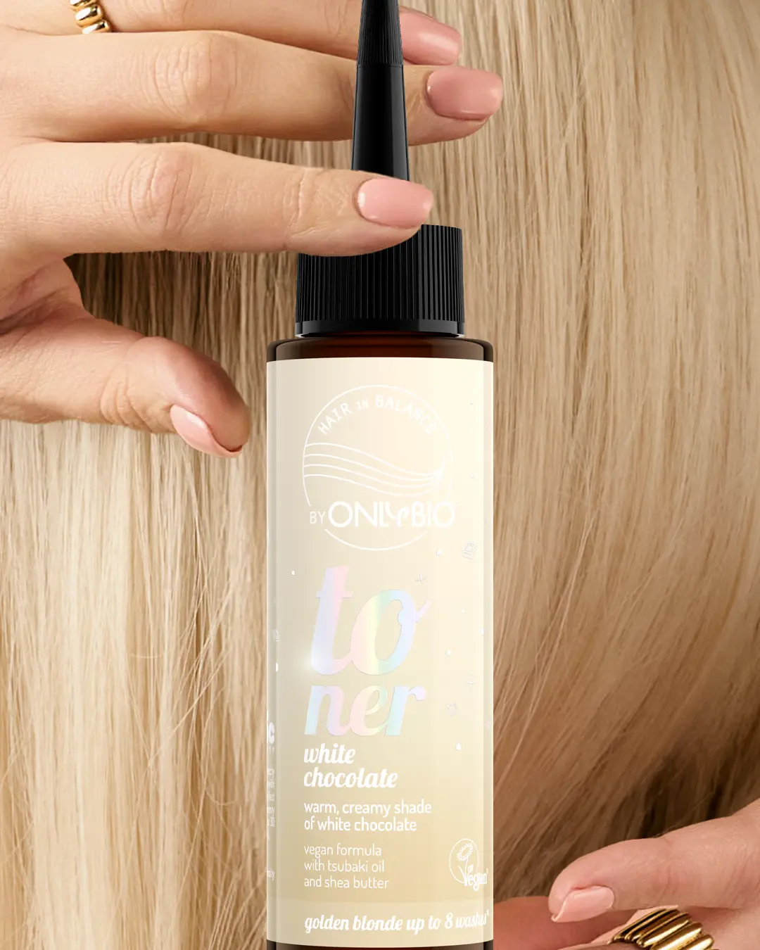 A bottle of OnlyBio hair toner against a background of hair