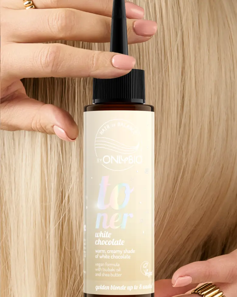A bottle of OnlyBio hair toner against a background of hair