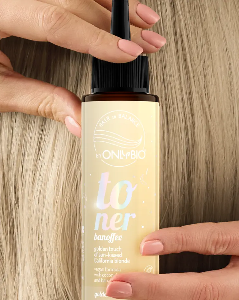 A bottle of OnlyBio hair toner against a background of hair