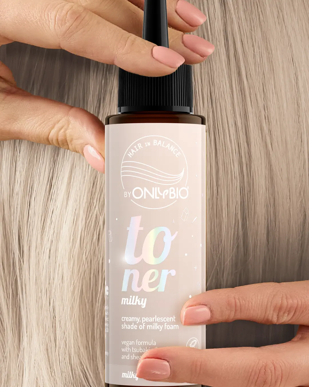A bottle of OnlyBio hair toner against a background of hair