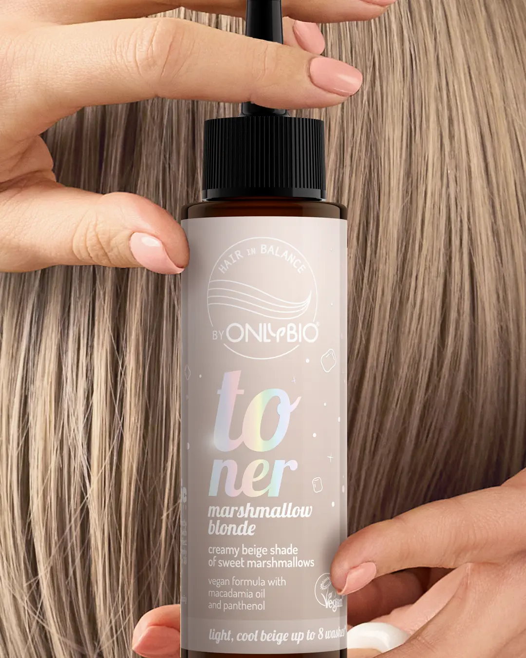 A bottle of OnlyBio hair toner against a background of hair