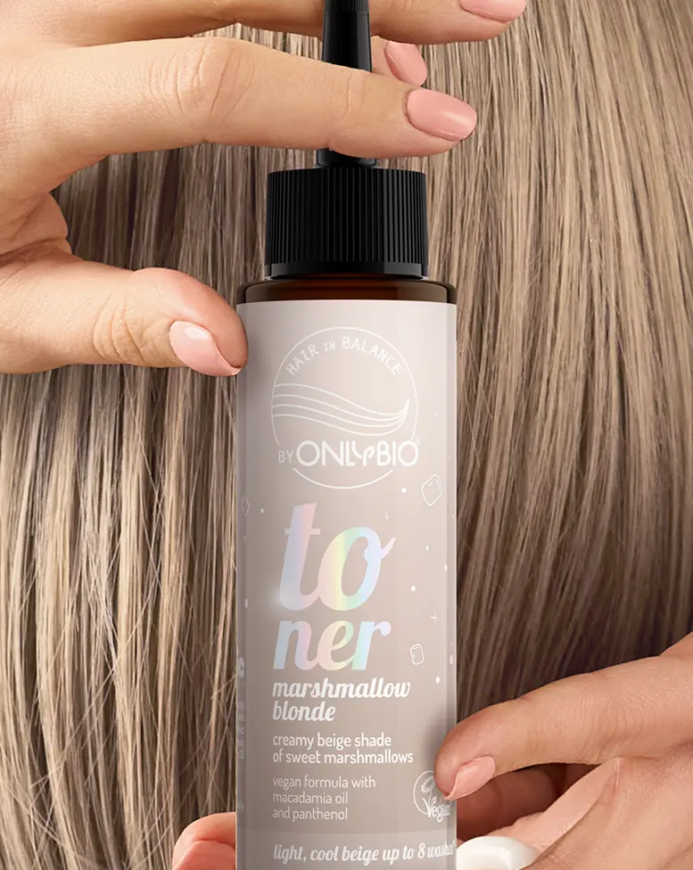 A bottle of OnlyBio hair toner against a background of hair