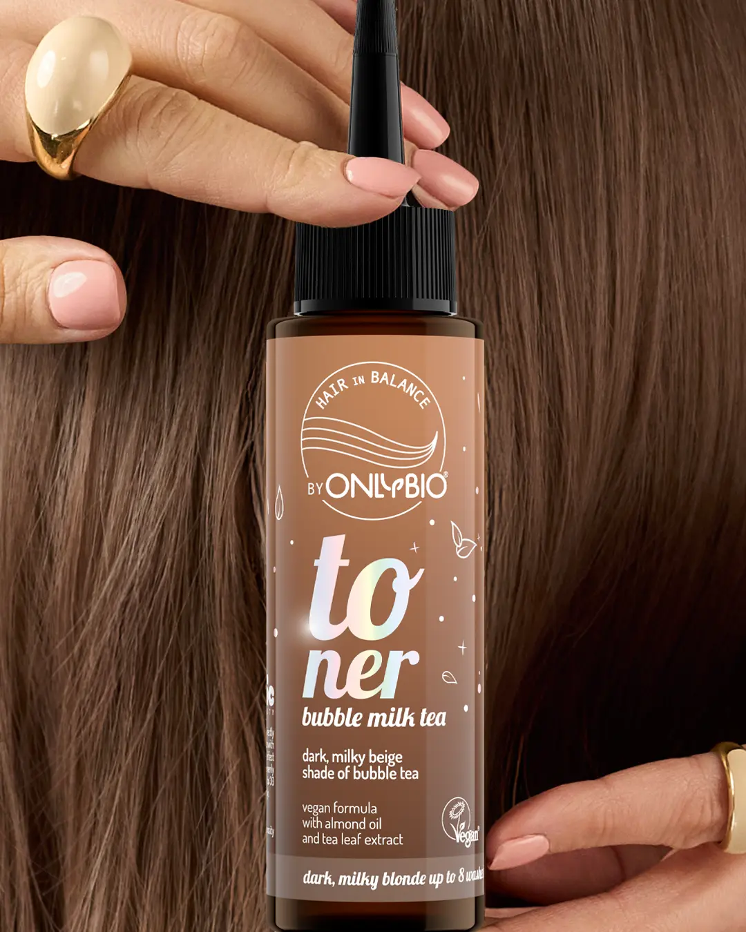 A bottle of OnlyBio hair toner against a background of hair