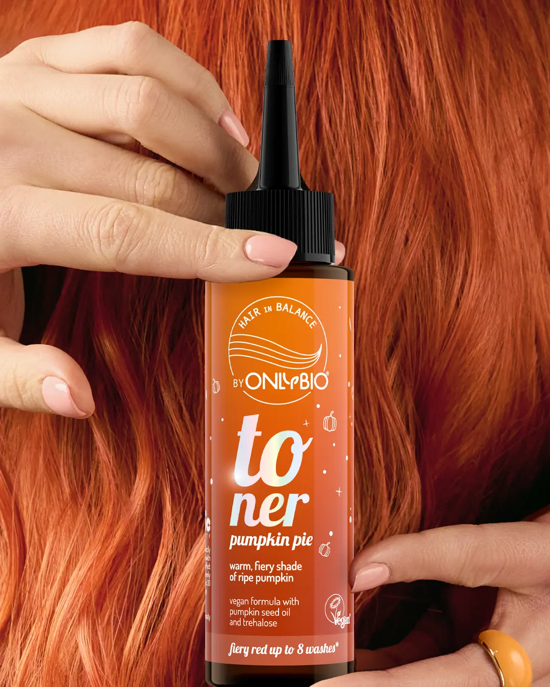 A bottle of OnlyBio hair toner against a background of hair