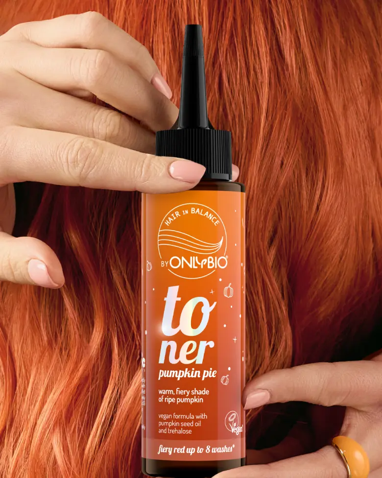 A bottle of OnlyBio hair toner against a background of hair