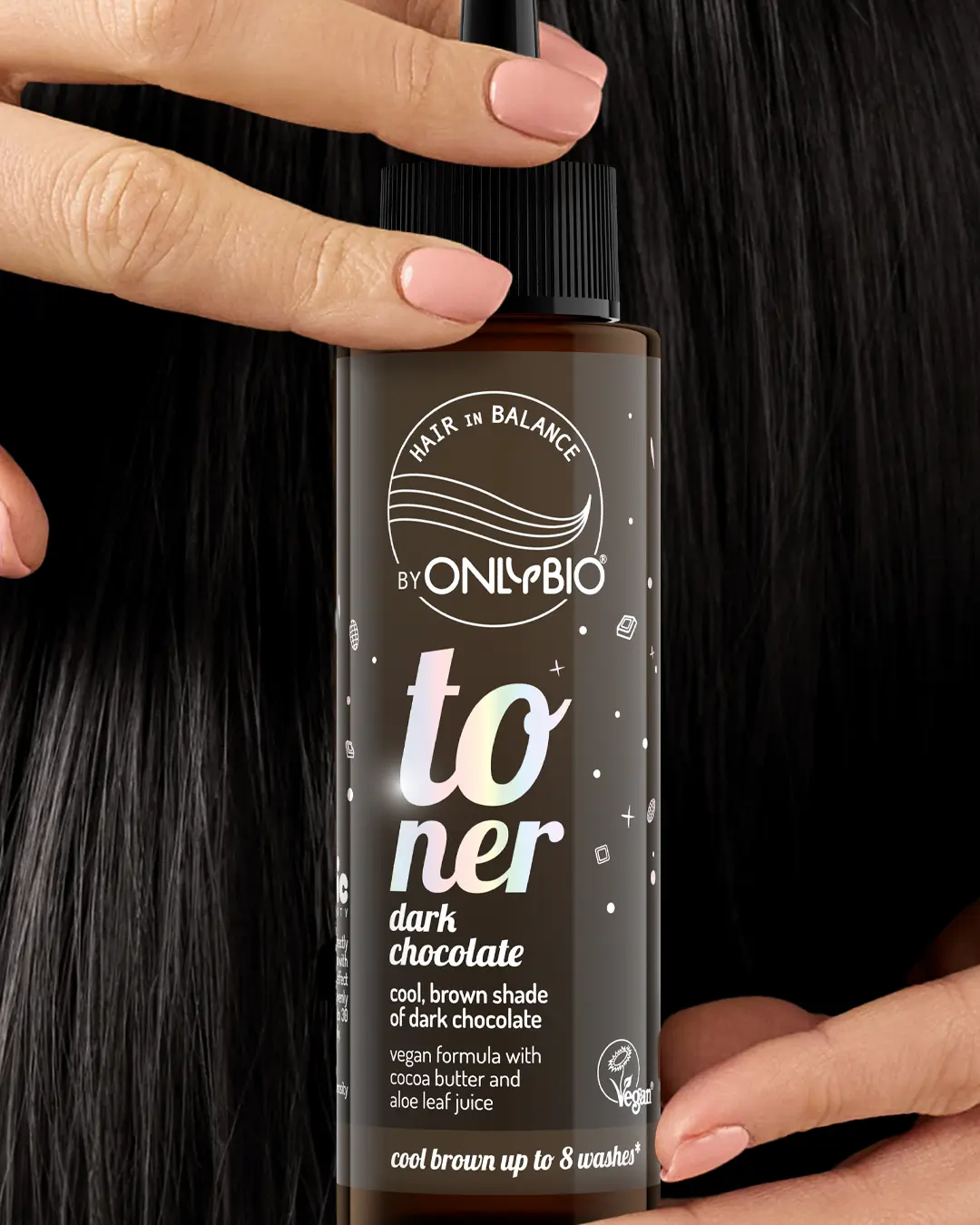 A bottle of OnlyBio hair toner against a background of hair