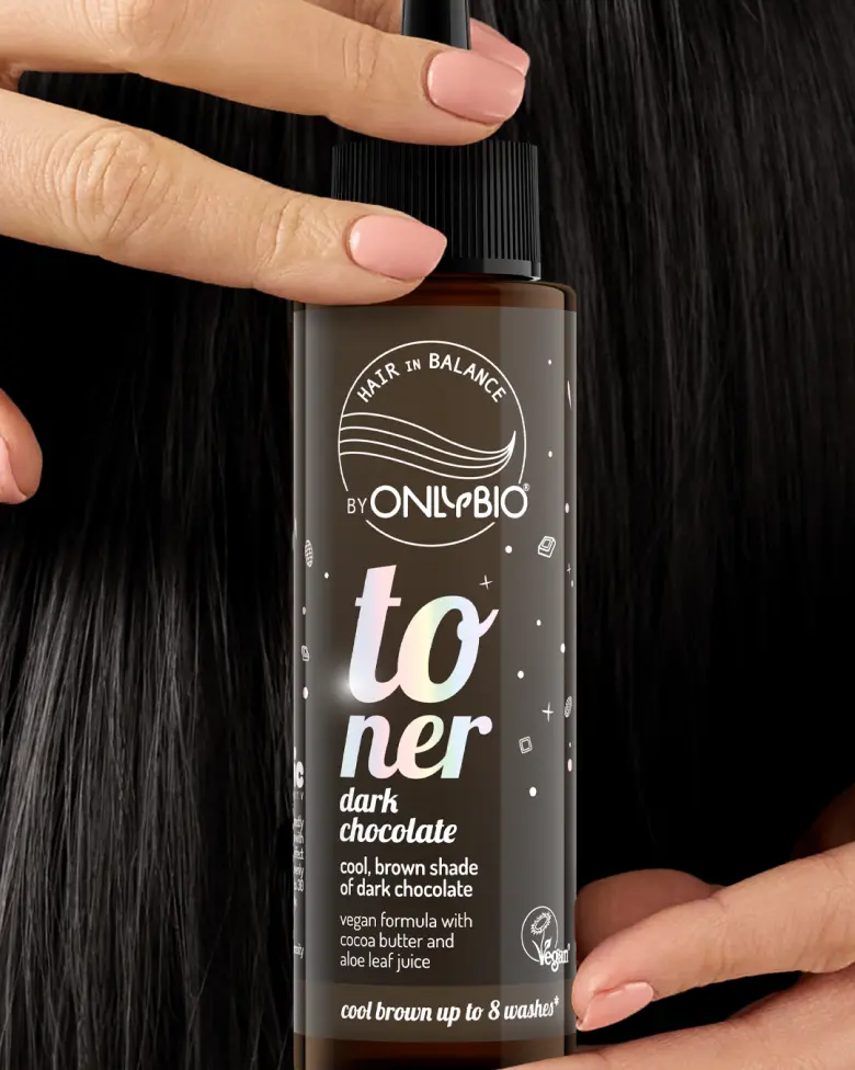 A bottle of OnlyBio hair toner against a background of hair