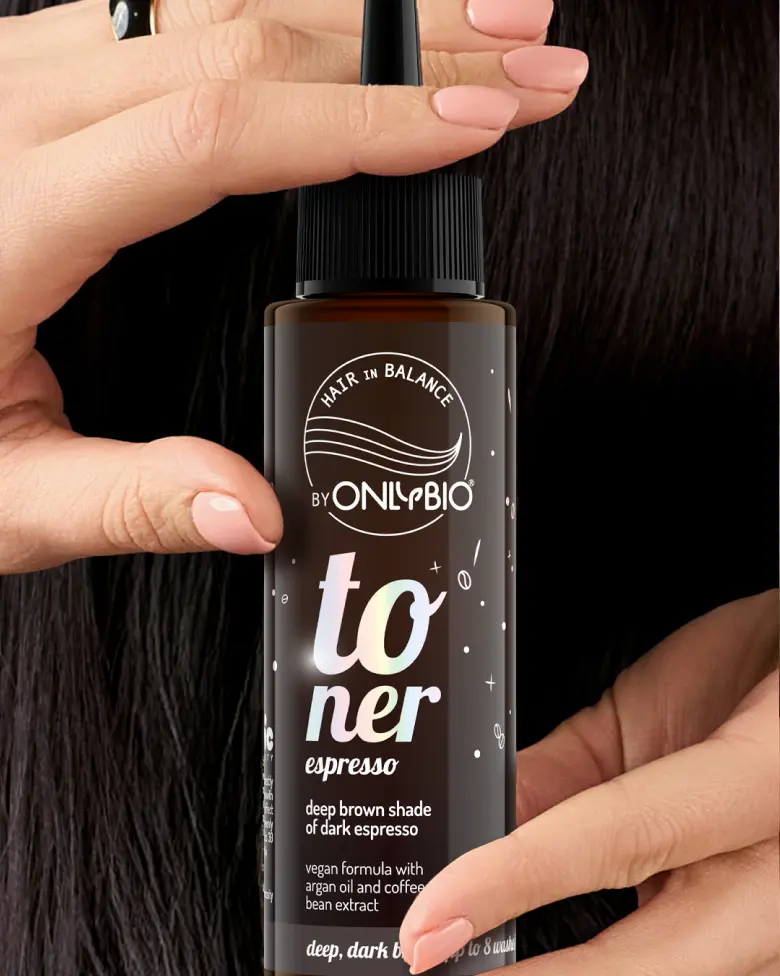 A bottle of OnlyBio hair toner against a background of hair