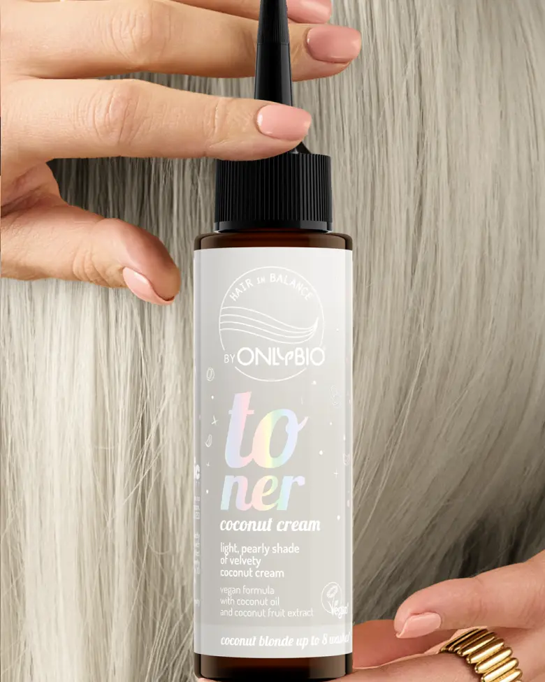 A bottle of OnlyBio hair toner against a background of hair