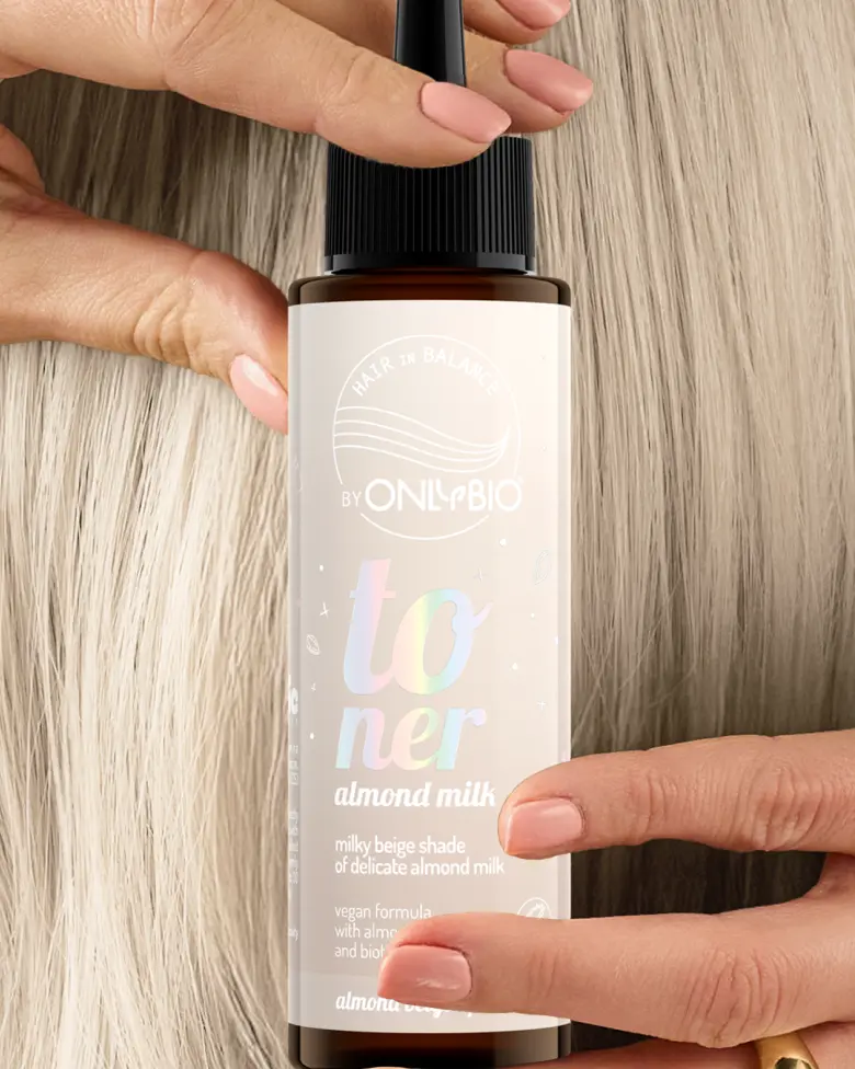 A bottle of OnlyBio hair toner against a background of hair