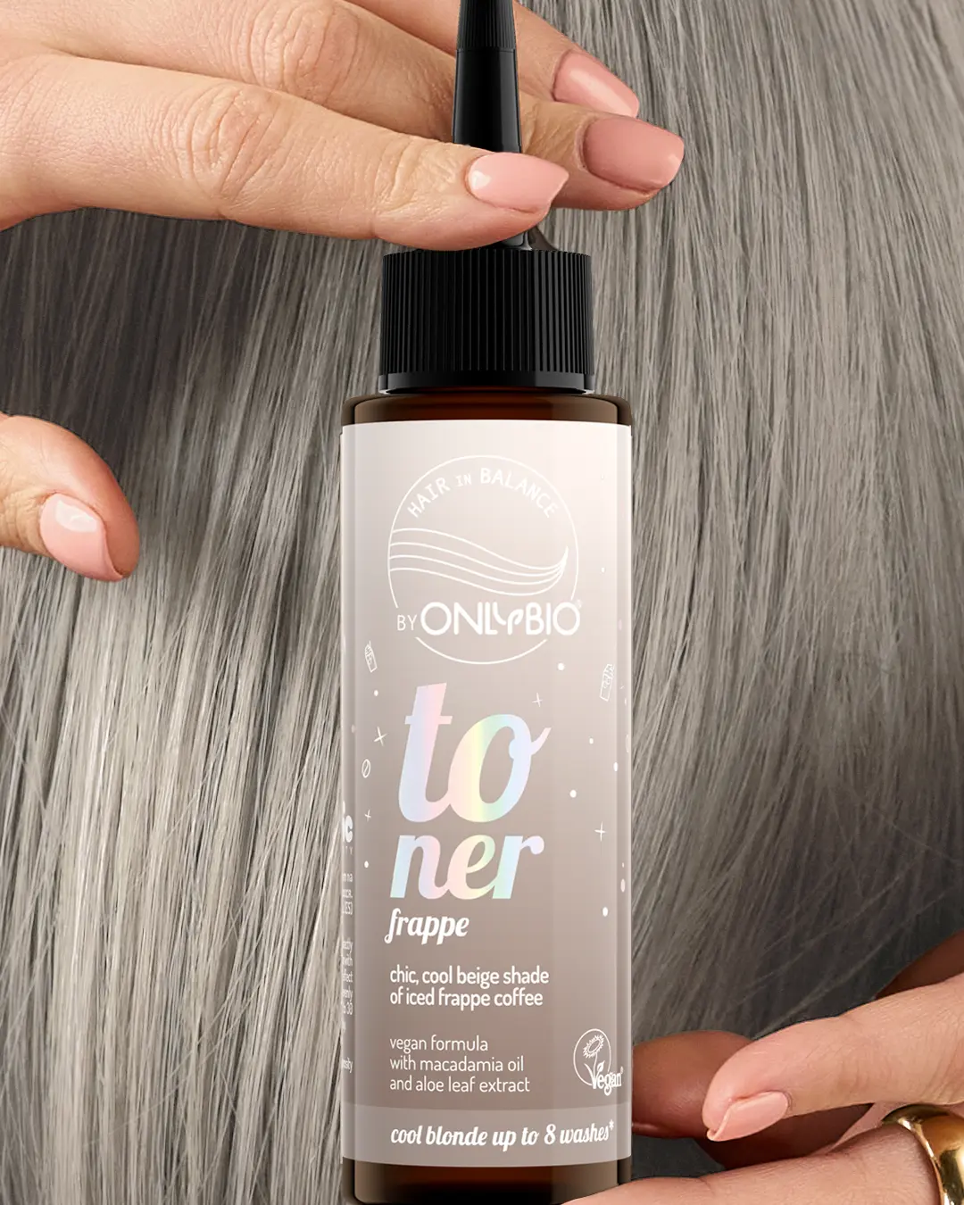 A bottle of OnlyBio hair toner against a background of hair