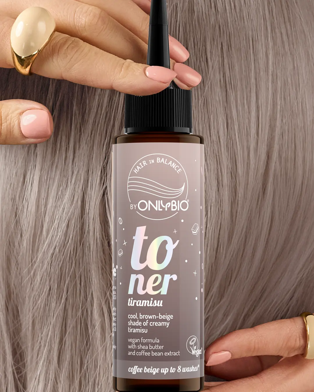 A bottle of OnlyBio hair toner against a background of hair