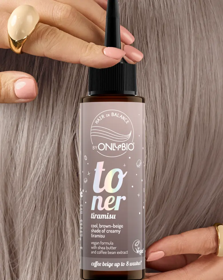 A bottle of OnlyBio hair toner against a background of hair